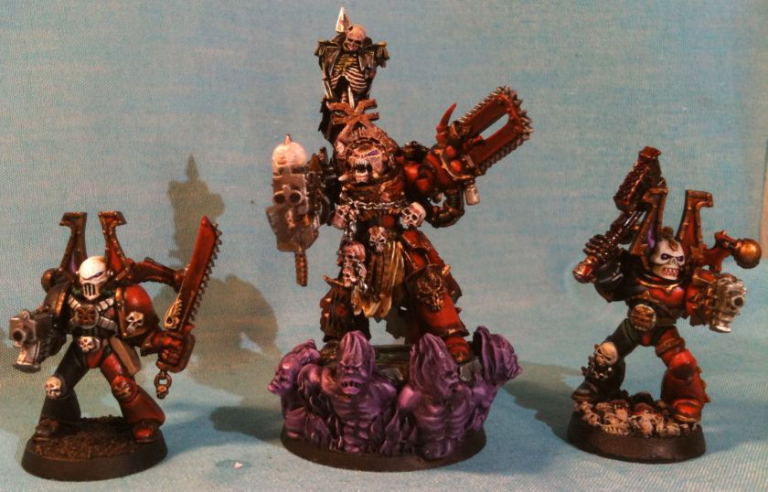 The three Khorne models I've painted in dark red armor